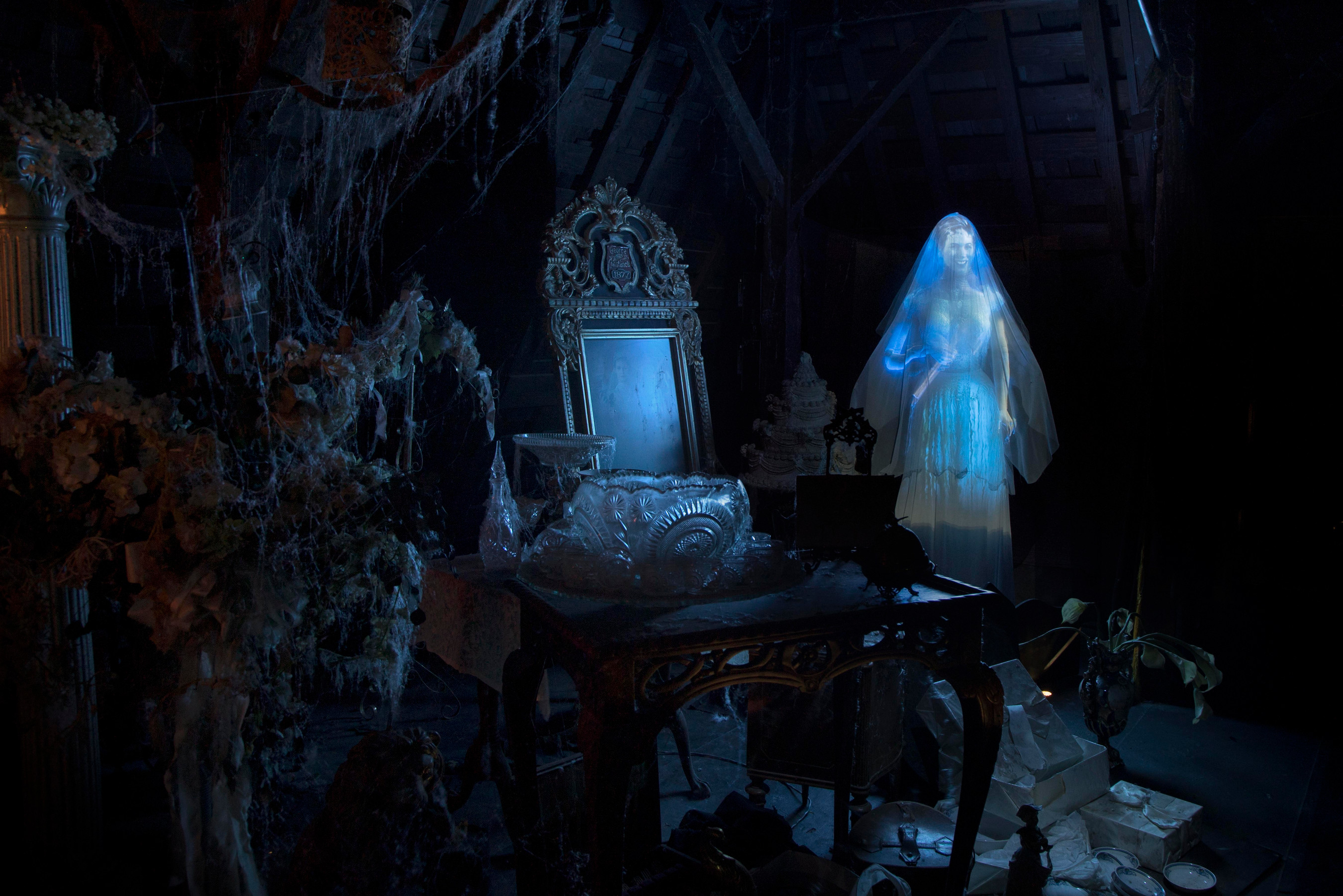 Guests touring the Haunted Mansion at Disneyland Park encounter many spooky...